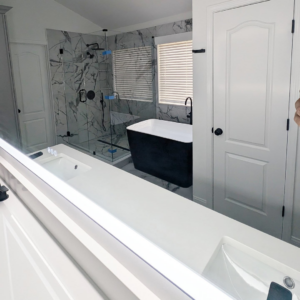 A beautifully remodeled bathroom featuring a double vanity, glass shower, and freestanding tub by Ensotile - Atlanta Bathroom Remodeling in Stone Mountain, GA