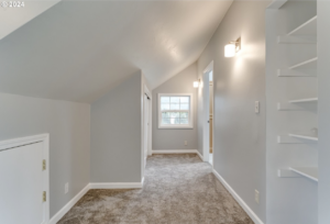 A remodeled hallway featuring new carpet and built-in shelves by Green Peaks Painting and Remodeling in Elmira, OR