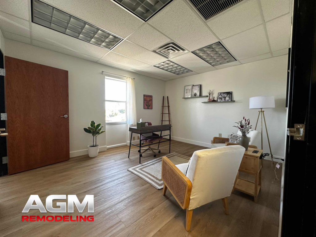 A newly remodeled office room featuring new flooring, updated lighting, and fresh paint by AGM Remodeling LLC in Scottsdale, AZ.