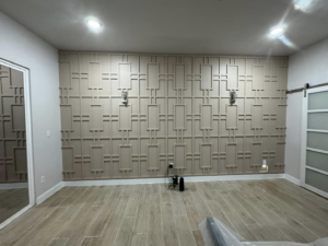A newly remodeled room featuring decorative wall paneling and a modern sliding door by D.R. Construction in El Paso, TX.