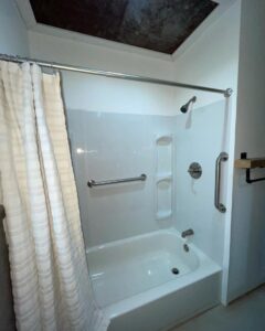 A renovated bathroom featuring a new tub and shower unit by Creative Touch Renovations LLC in Harrisburg, PA.