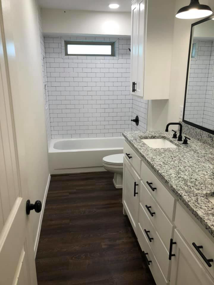 A newly renovated bathroom with subway tile shower and modern vanity by Mason Contracting in Levittown, PA.
