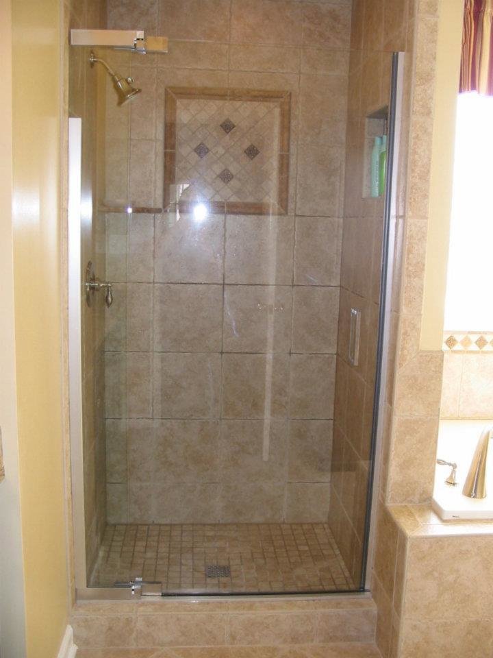 A renovated bathroom featuring a modern tiled shower with a clear glass door, a project by WHE Construction in Virginia Beach, VA