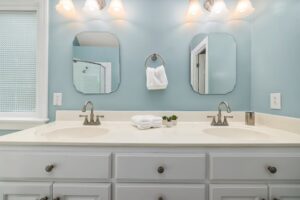 A renovated bathroom vanity with double sinks and modern fixtures by Orival Property Services in Boston, MA.