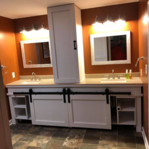 A newly renovated bathroom vanity with dual sinks and modern cabinetry by Peterson Home Improvement LLC in Highland, NY.