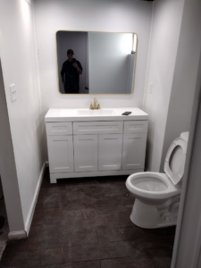 A newly renovated bathroom featuring a new vanity, sink, and toilet by I.B. Remodeling LLC in Dayton, OH.