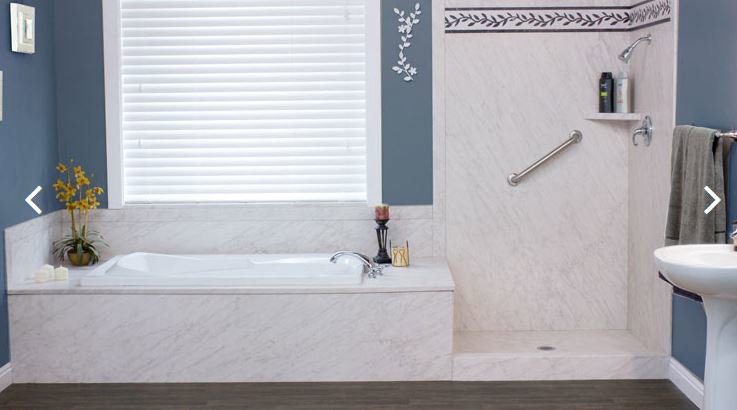 A renovated bathroom featuring a large soaking tub and a modern walk-in shower, completed by Men Construction in Lowell, MA.