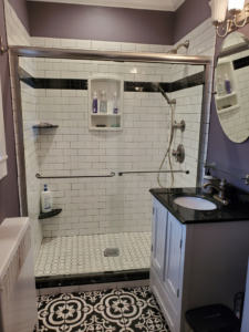A beautifully renovated bathroom featuring a tiled walk-in shower and new vanity by DBB, Inc. in Harrisonburg, VA.