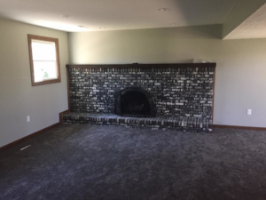 A beautifully renovated brick fireplace in a living room by Kline Custom Homes and Remodelers in Canton, OH.