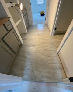 A renovated hallway featuring new tile flooring and built-in cabinets by Creative Touch Renovations LLC in Harrisburg, PA.