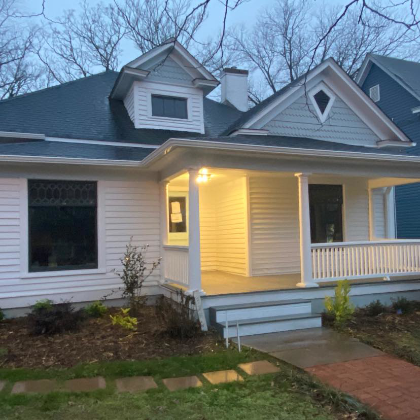 A renovated home exterior with a porch and landscaping, showcasing work by Redress & Renovate in Winston-Salem, NC.