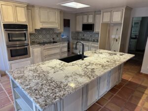 A beautifully renovated kitchen featuring a large granite island and new cabinets by Lay's Remodeling LLC in El Paso, TX