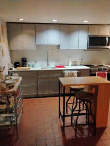 A renovated kitchen featuring grey cabinets, white subway tile backsplash, and stainless steel appliances by Amaro home improvement llc in Danbury, CT.