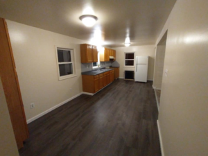 Renovated kitchen with new cabinets, dark countertops, and wood-look flooring by Jones Construction & Lawn Services, Newport, PA