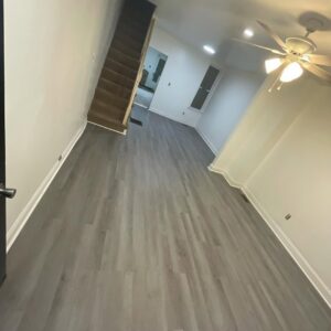 A renovated living area with new flooring and freshly painted walls by Creative Touch Renovations LLC in Harrisburg, PA.