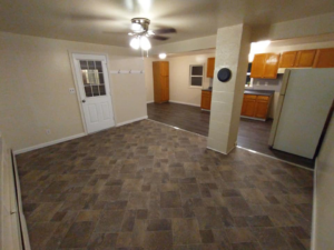 Renovated living area with new tile-look flooring and a pillar by Jones Construction & Lawn Services, Newport, PA