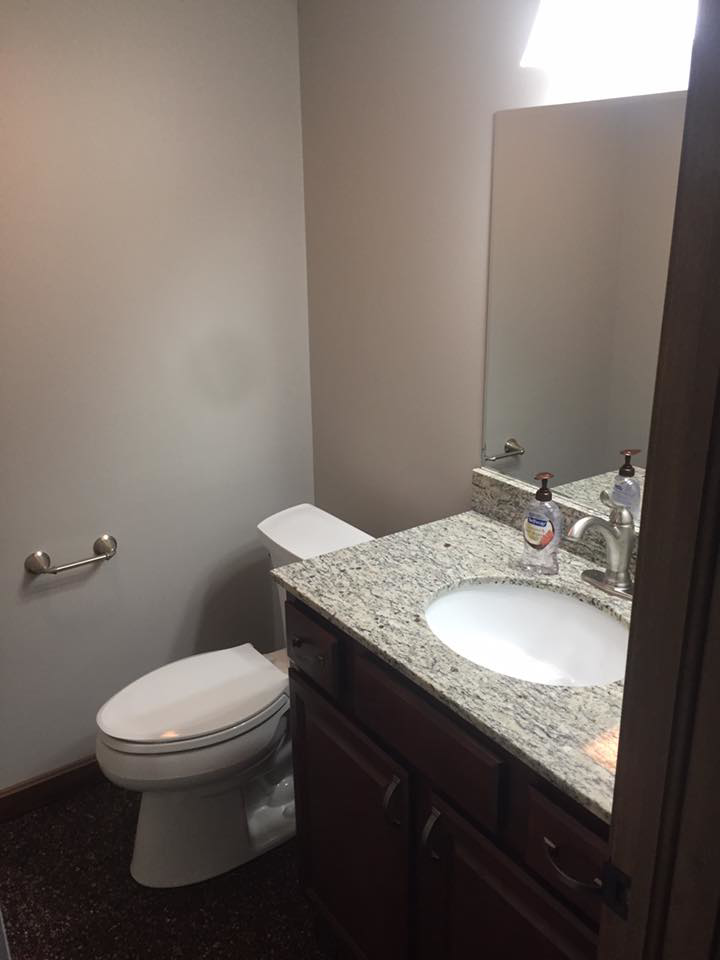 A renovated powder room with a new vanity, sink, and toilet by Kline Custom Homes and Remodelers in Canton, OH.
