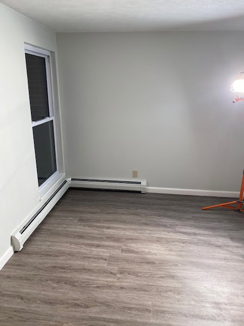 A newly renovated room featuring new flooring and freshly painted walls, completed by Sini's Handyman Services in Falmouth, ME.