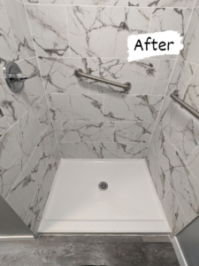 A renovated shower with new tiling, a clean shower pan, and grab bars installed by Joel's Handyman in Ogden, UT.