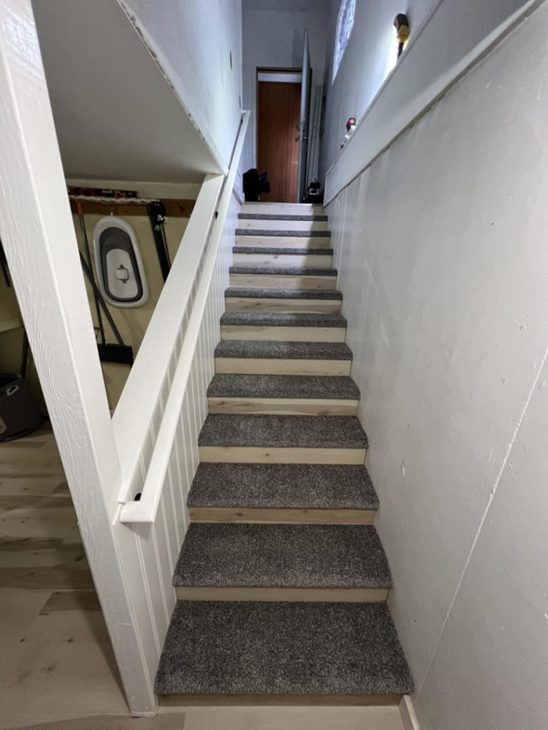 Renovated staircase with new carpet treads and painted risers by JKM Services in Solon, OH.