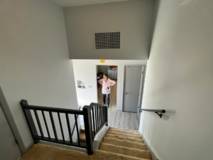 A renovated staircase featuring new black railings and freshly painted walls by Lambert's Residential Painting And More LLC in Fort Wayne, IN.