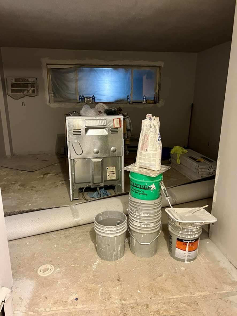 Renovation materials and paint buckets in a room under construction by Get It Done in Sioux Falls, SD.