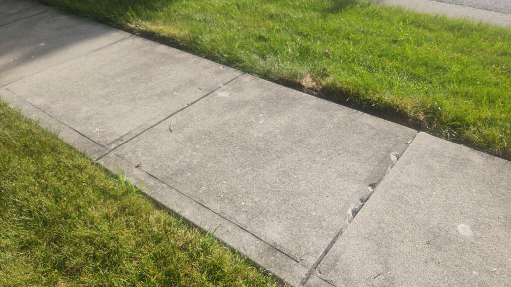 A repaired and leveled concrete sidewalk with filled holes, demonstrating the quality work of A1 Concrete Leveling Cincinnati/NKY in Cincinnati, OH.