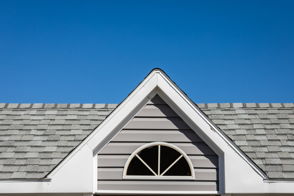 Close-up of a residential asphalt shingle roof and gable siding by Campos & Son Roofing and Construction in El Paso, TX