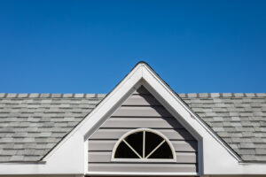 Close-up of a residential asphalt shingle roof and gable siding by Campos & Son Roofing and Construction in El Paso, TX
