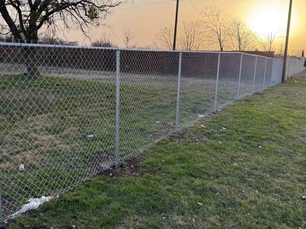 A durable residential chain link fence installed by Tin Star Fencing in Fort Worth, TX