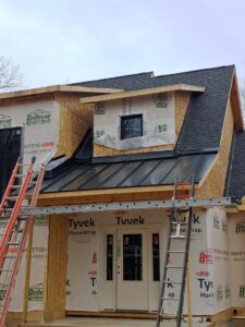 Residential construction with Tyvek wrap and partial metal roof installation by JB Home Improvement Services in Sanford, FL.