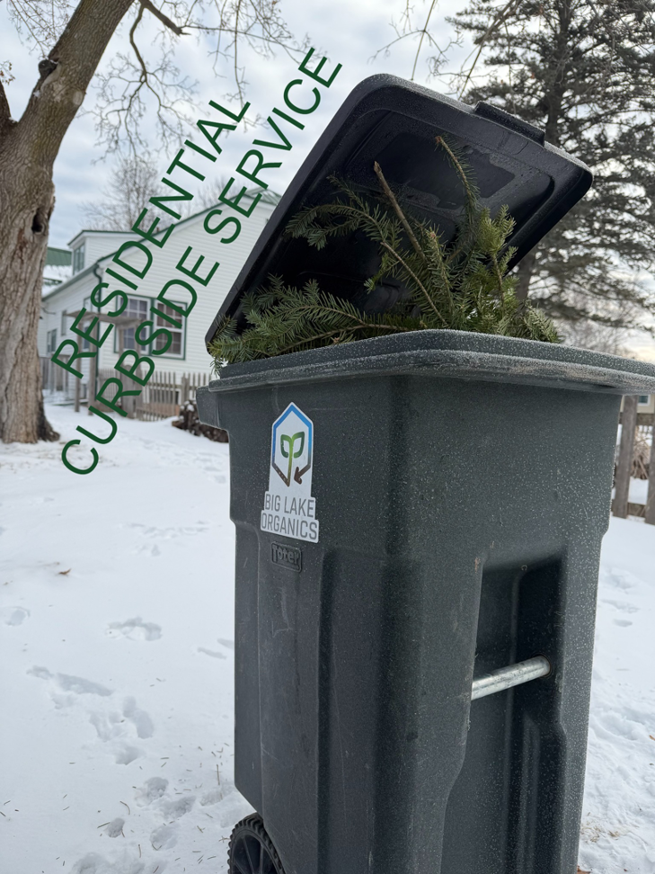 A Big Lake Organics bin filled with branches for residential curbside organic waste pickup in Ashland, WI.