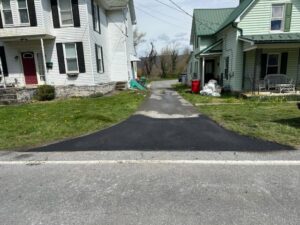 A newly paved residential driveway connecting to a main road by Angeles Contractors LLC in New Oxford, PA.