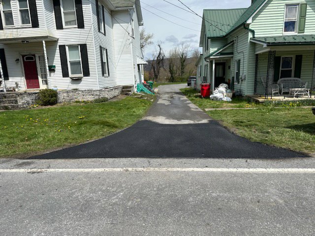 A newly paved residential driveway connecting to a main road by Angeles Contractors LLC in New Oxford, PA.
