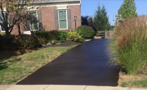 A newly sealcoated residential asphalt driveway, showcasing quality work by Cincy SealCoating in Morrow, OH.