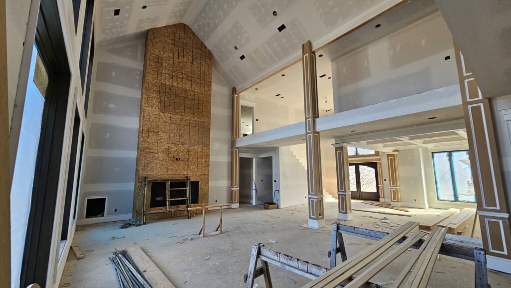 Interior of a residential home under construction, showing new drywall installation by Acosta Painting LLC in Jonesboro, AR.