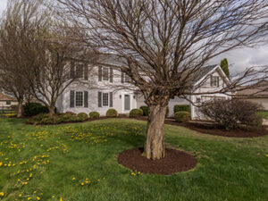 A large, well-maintained residential home exterior, showcasing a completed project by Elk Building Services in Toledo, OH.