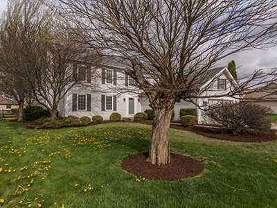 A large, well-maintained residential home exterior, showcasing a completed project by Elk Building Services in Toledo, OH.