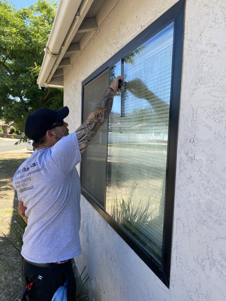 Professional residential exterior window cleaning using a squeegee by Bring The Pane in Lewiston, ID.