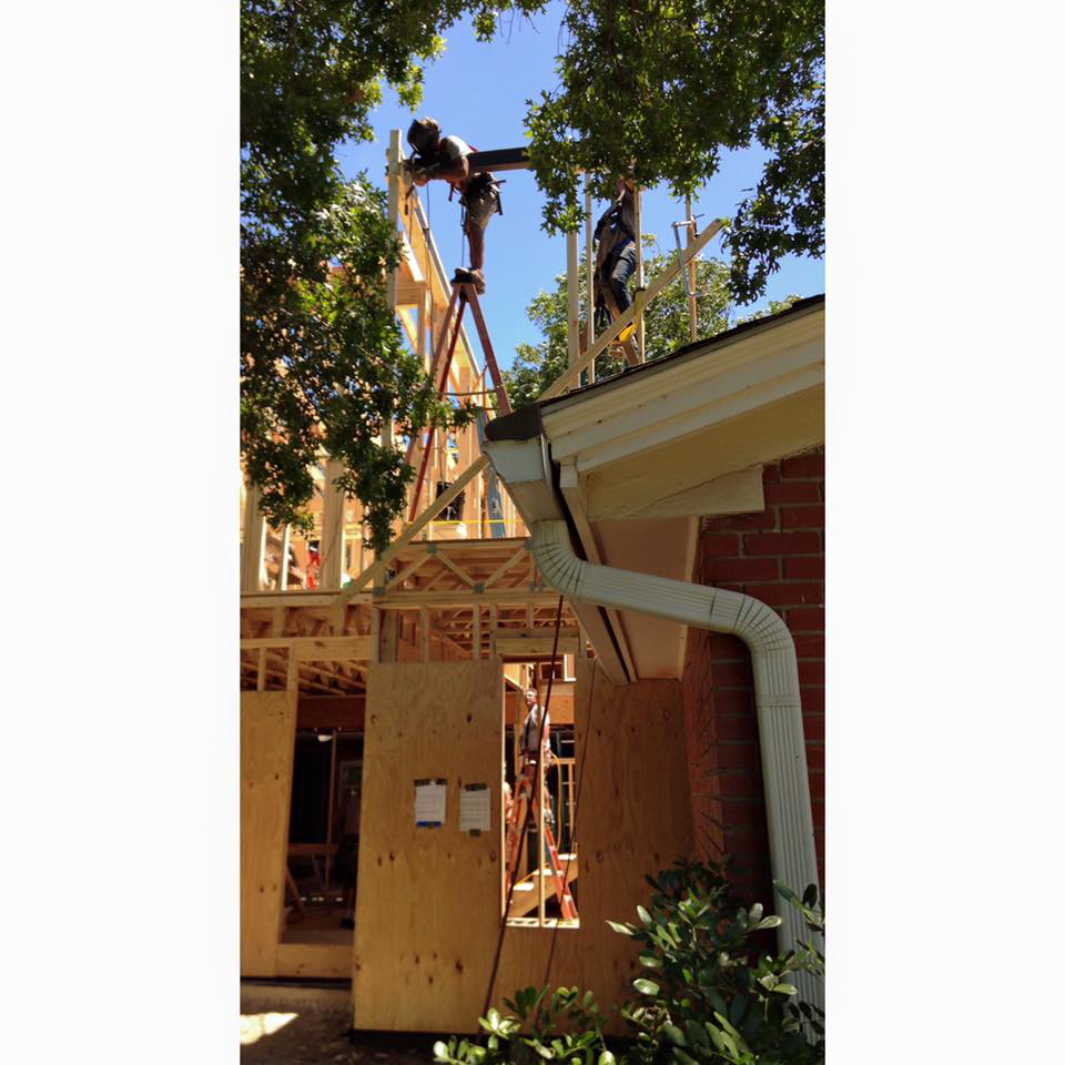 Workers framing a new residential construction project by Drophouse Design in Austin, TX