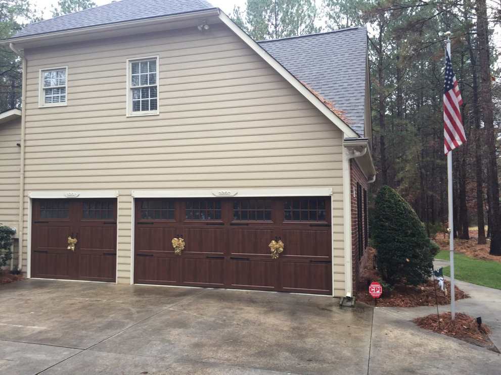 Residential garage door installation on a house by Harold Carpenter Overhead Door inc in Oshkosh, WI.