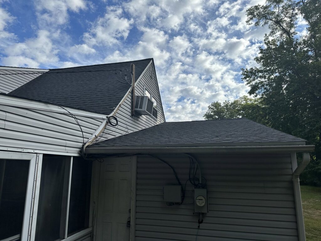 A residential house with a new shingle roof and a screened porch addition by RHI Construction Inc in Philadelphia, PA.