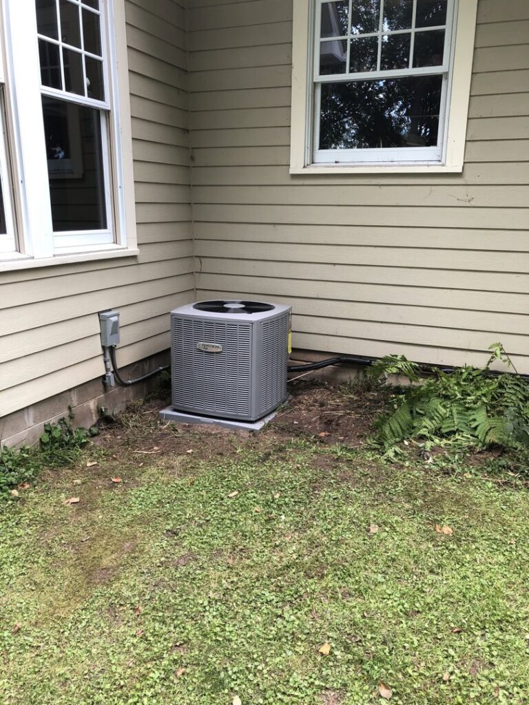 Residential outdoor HVAC unit installation next to a home by Northern Air Plumbing & Heating in Aitkin, MN