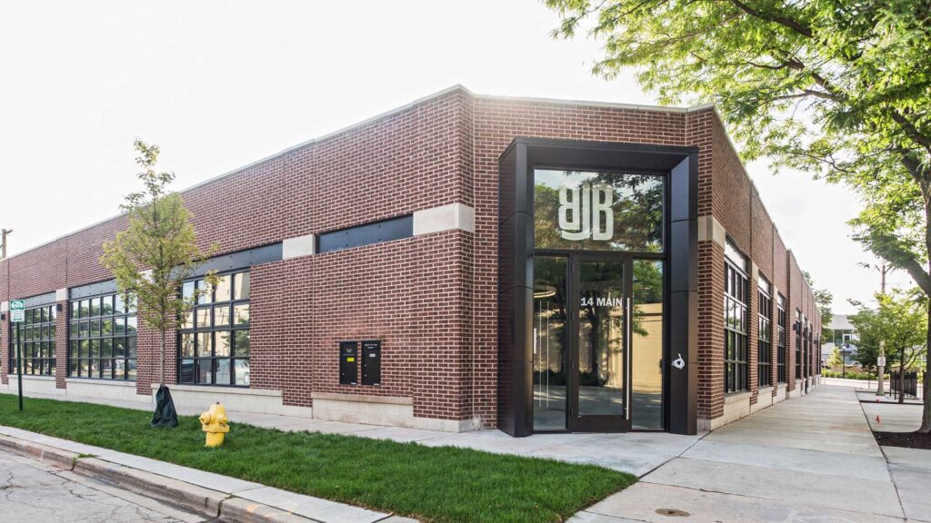 A newly renovated residential interior with light grey walls and a modern staircase by ETI Construction in Chicago, IL.