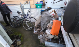 A residential junk pile with old bicycles and debris awaiting pickup by Squirrel Squad LLC in Portland, OR.