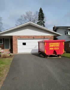 A red dumpster from Affordable Dumpsters for residential junk removal in Watervliet, NY.