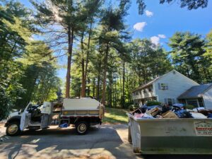 A large dumpster filled with residential junk and debris after a cleanup by Biohazard PRO in Boston, MA.