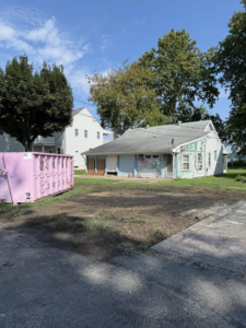 A pink dumpster from Dump It ready for residential junk removal in Middletown, DE
