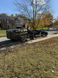 A junk removal trailer loaded with items parked on a residential street for Freedom Hauling in California, MD.