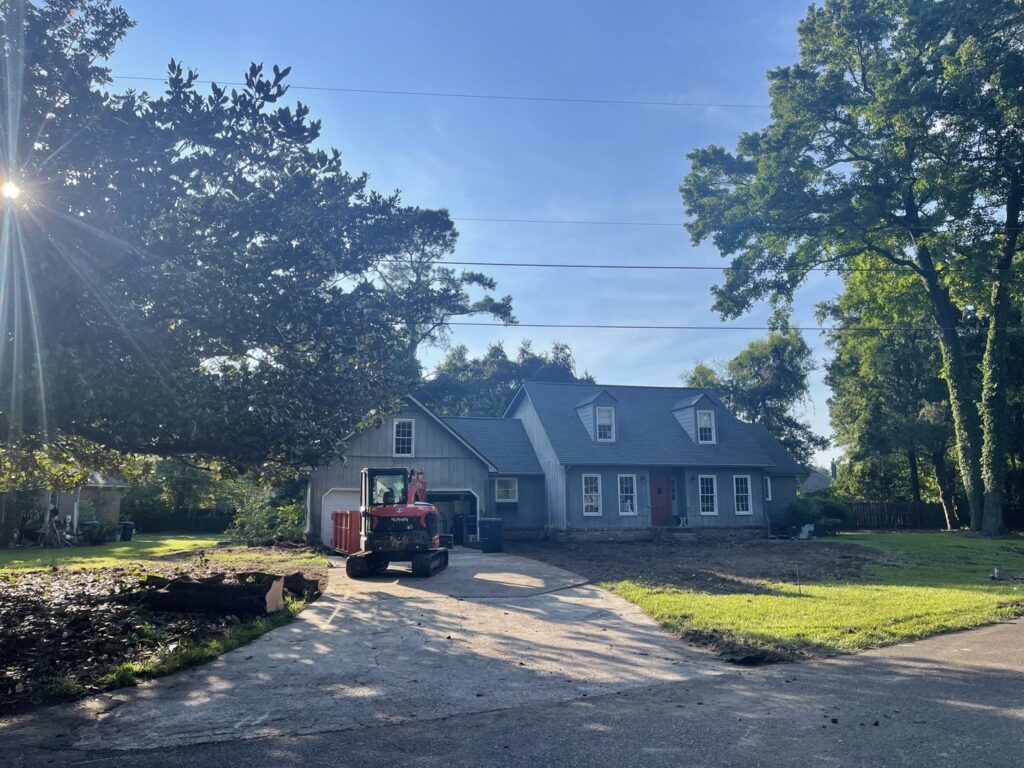 An excavator on a residential property after land clearing by Stewart Tree Service in Mount Pleasant, SC.